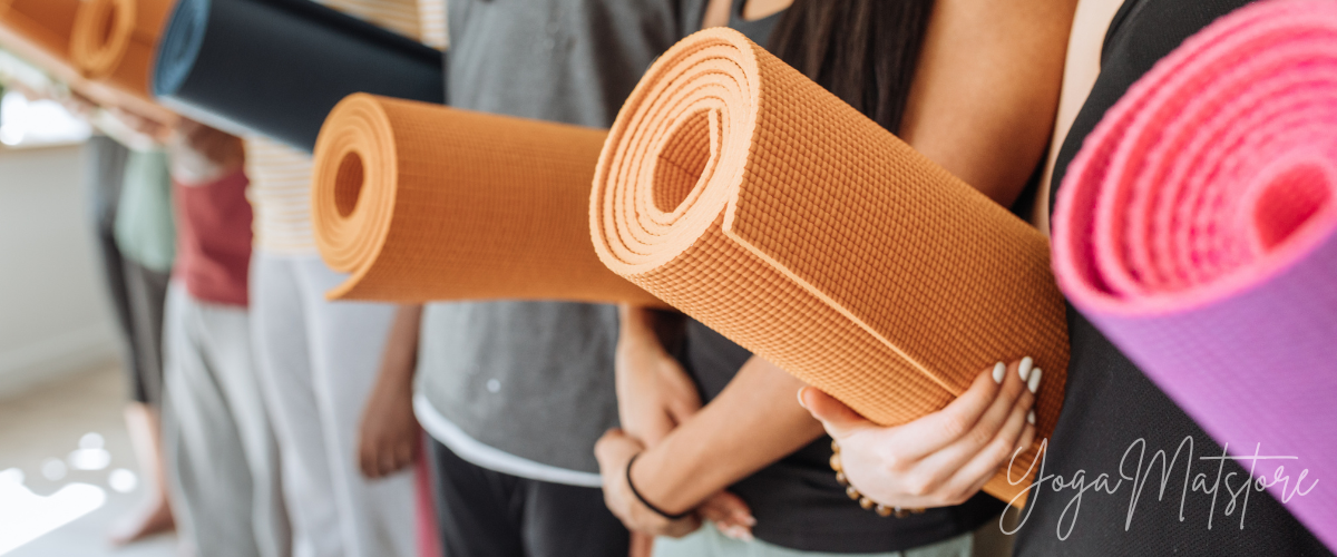 yoga practitioners seen with their thick yoga mats as you can see here.